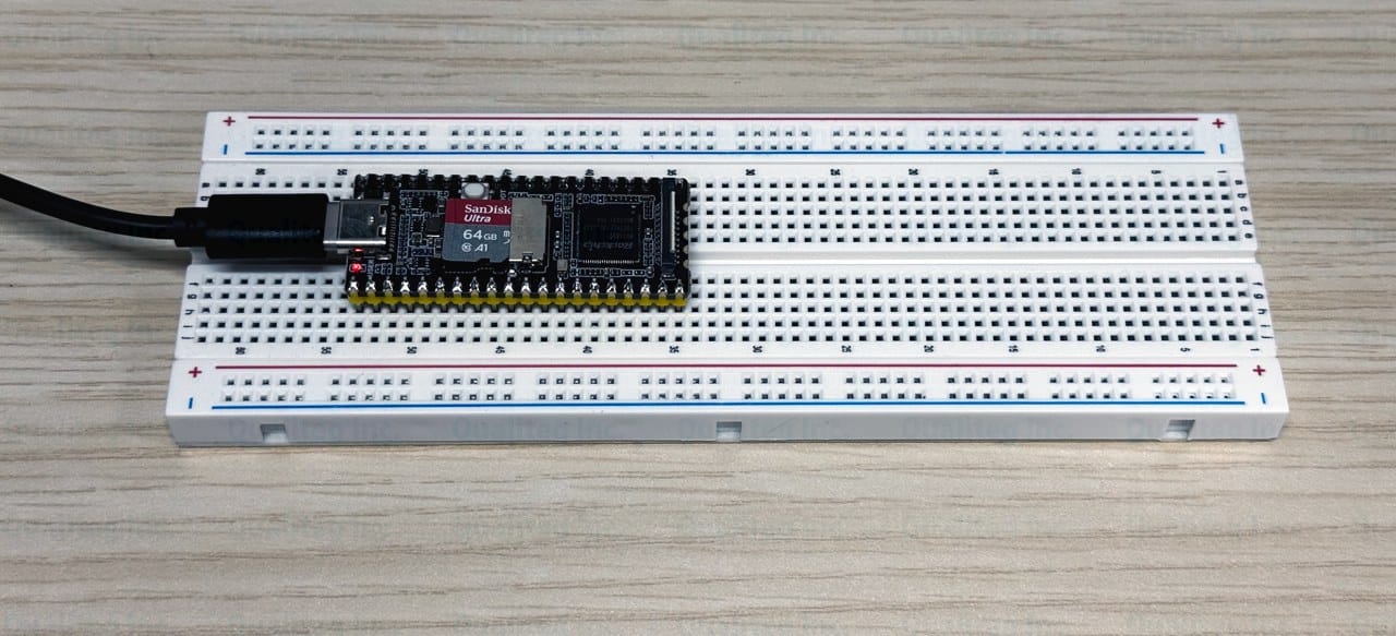 A Luckfox Pico M plugged into a breadboard and powered over USB-C, with a microSD card inserted